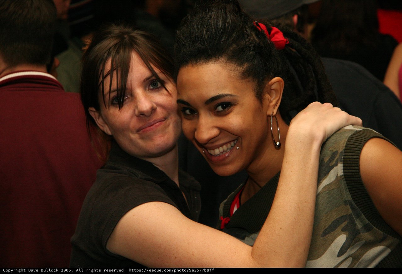 Two Friends Share a Warm Embrace at Party