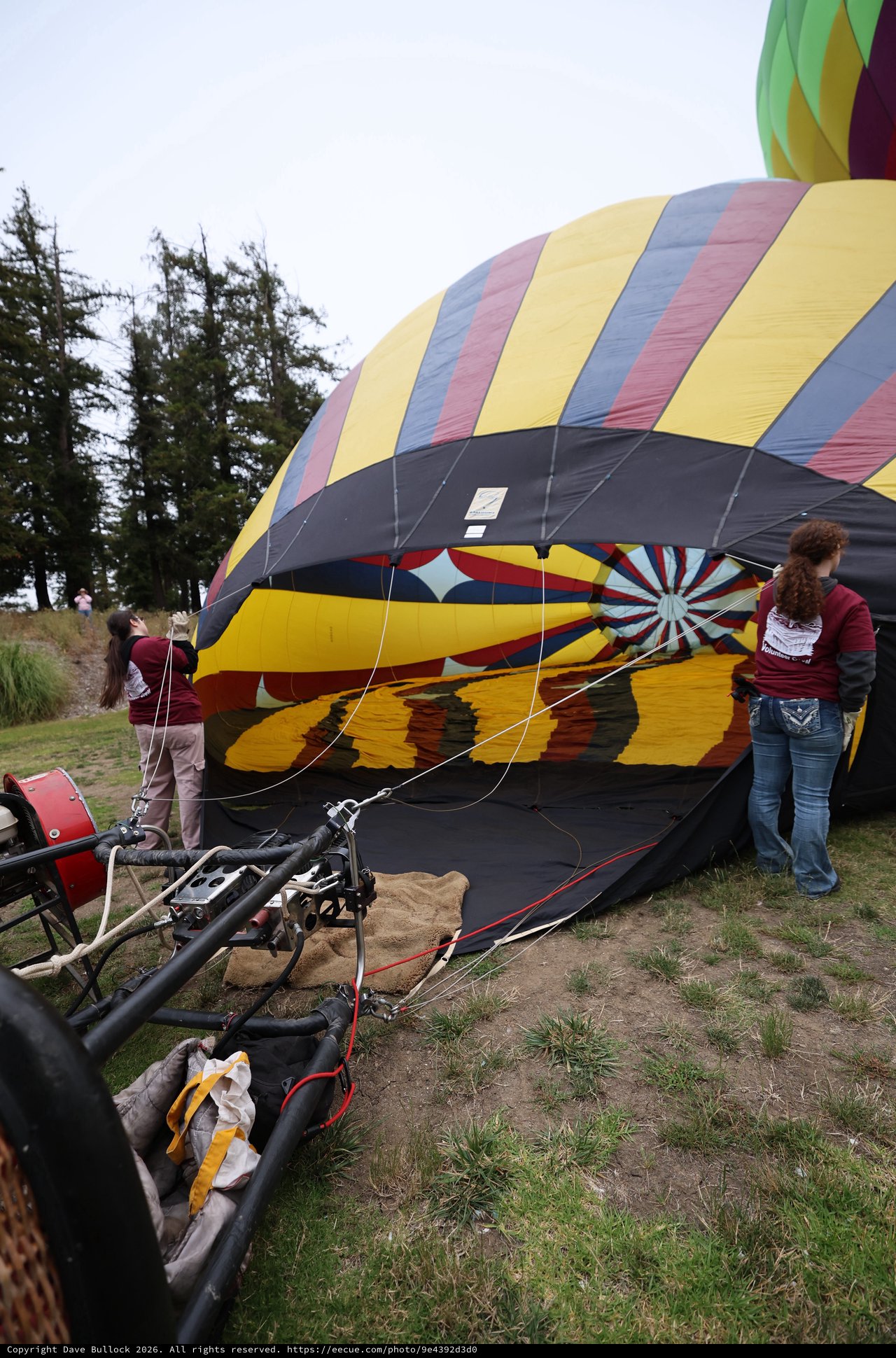 Volunteers Inflate Colorful Hot Air Balloon at Festival