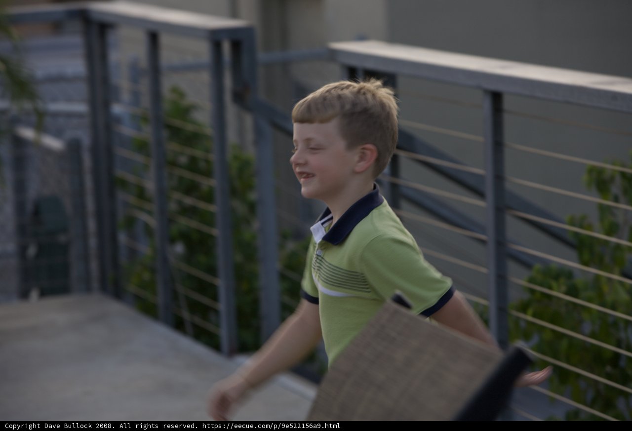 Young boy enjoying the view from his balcony