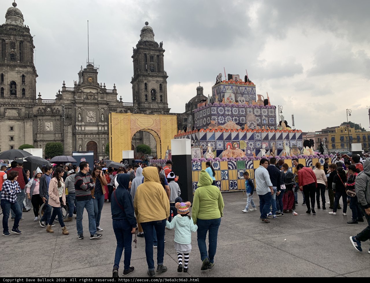 Crowded Plaza with Towering Building