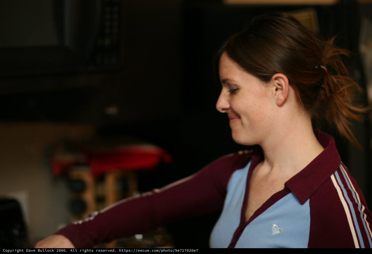 Young Woman Smiling in Burgundy Track Jacket