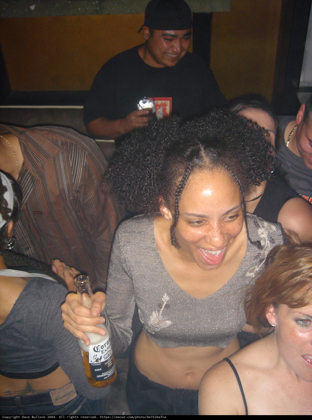Laughing Woman with Corona Beer at Nightclub Party