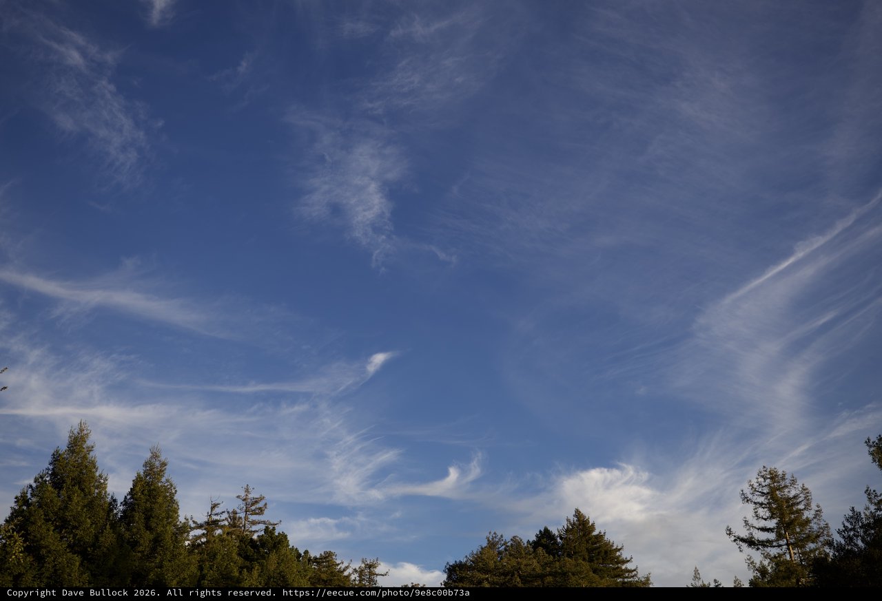 Wispy Cirrus Clouds Dance Across Blue Sky