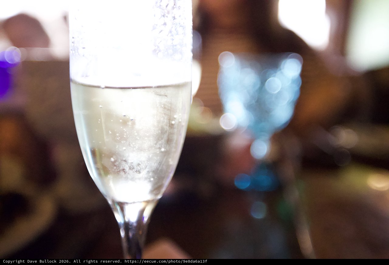 Sparkling Champagne Flute with Bokeh Light Effects