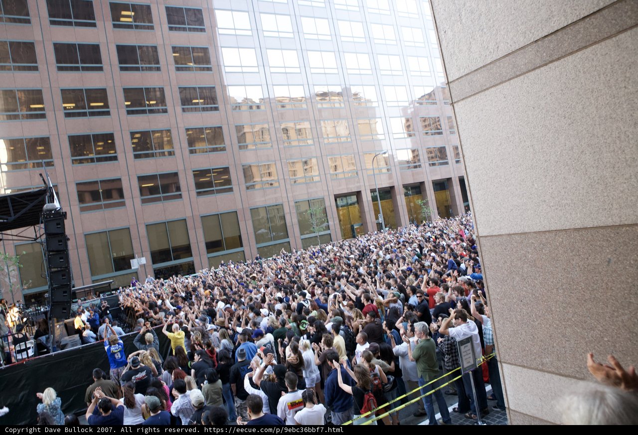 Grand Performances by Ozomatli Draws a Vibrant Crowd in Front of Urban Building