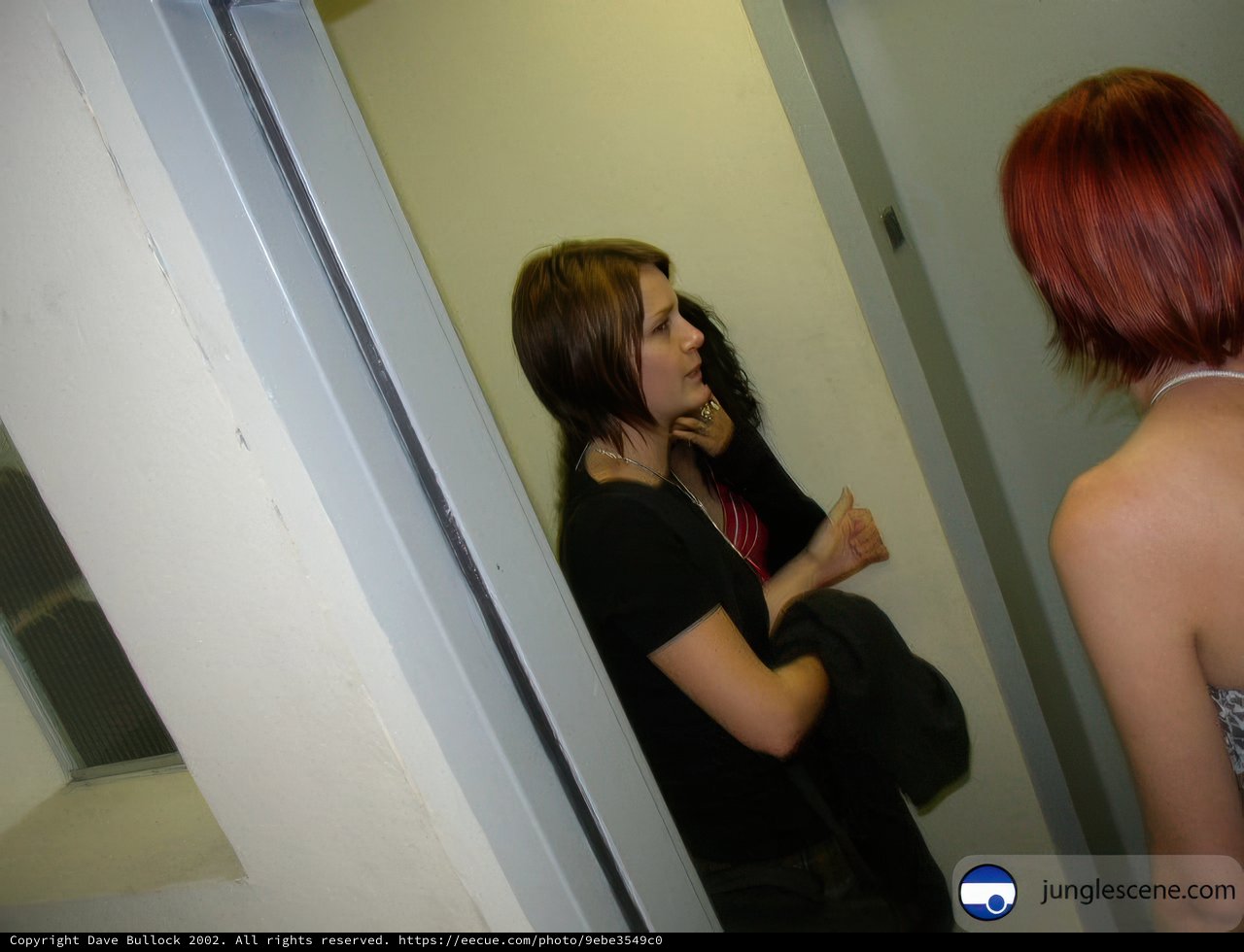 Red-haired Women Embrace in Intimate Dressing Room Moment