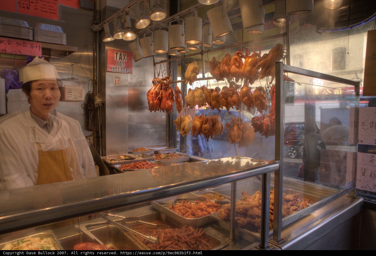 Man enjoying a meal at a bustling restaurant