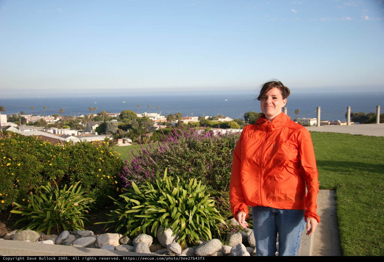 Woman in Orange Jacket Overlooking Coastal California Town