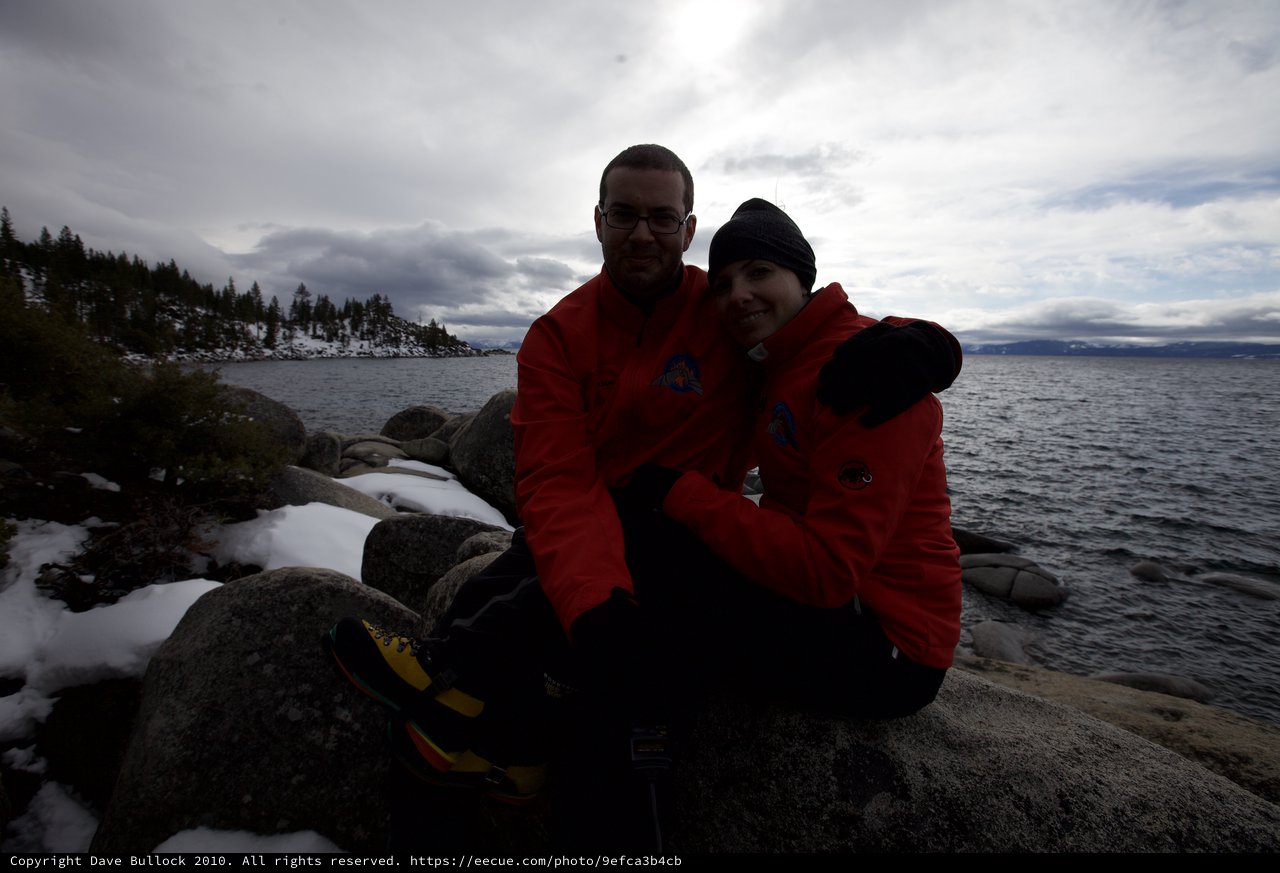 Couple Embracing at Snow-Dusted Lake Tahoe Shore