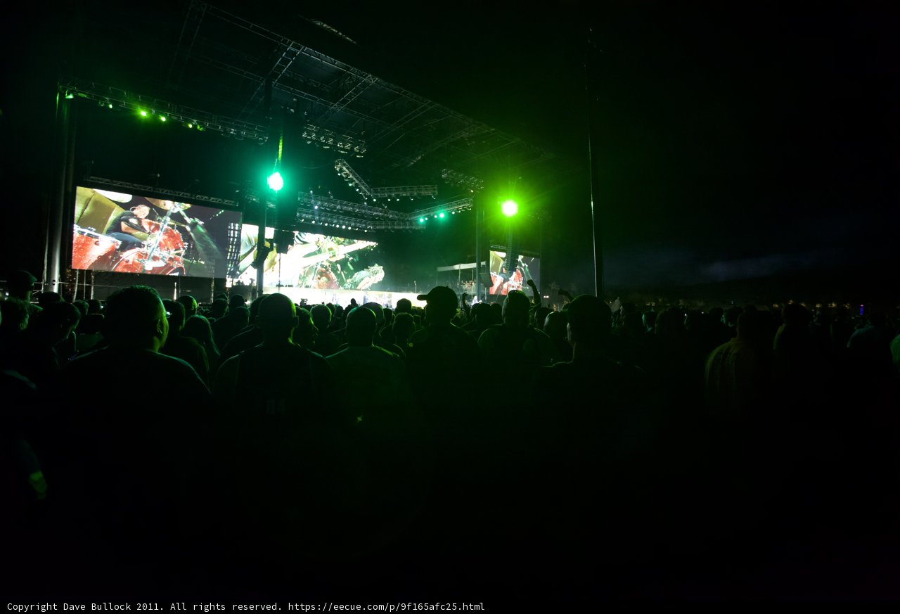 Green Spotlight on Rock Concert Crowd