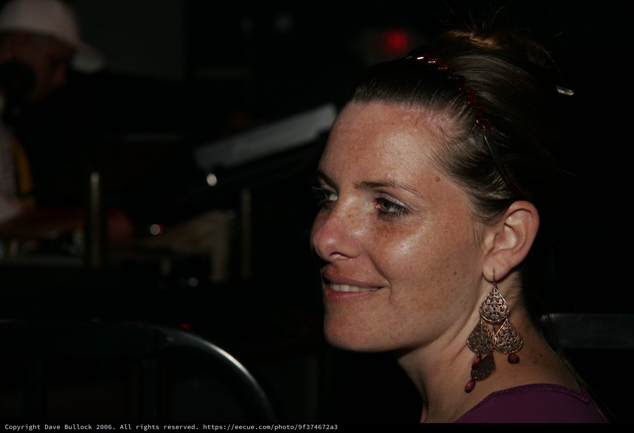 Woman in Profile Smiling at Nighttime Event