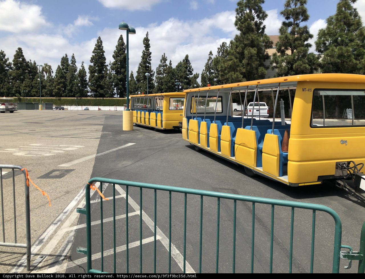 Bright Yellow Bus Parked Under a Blue Sky