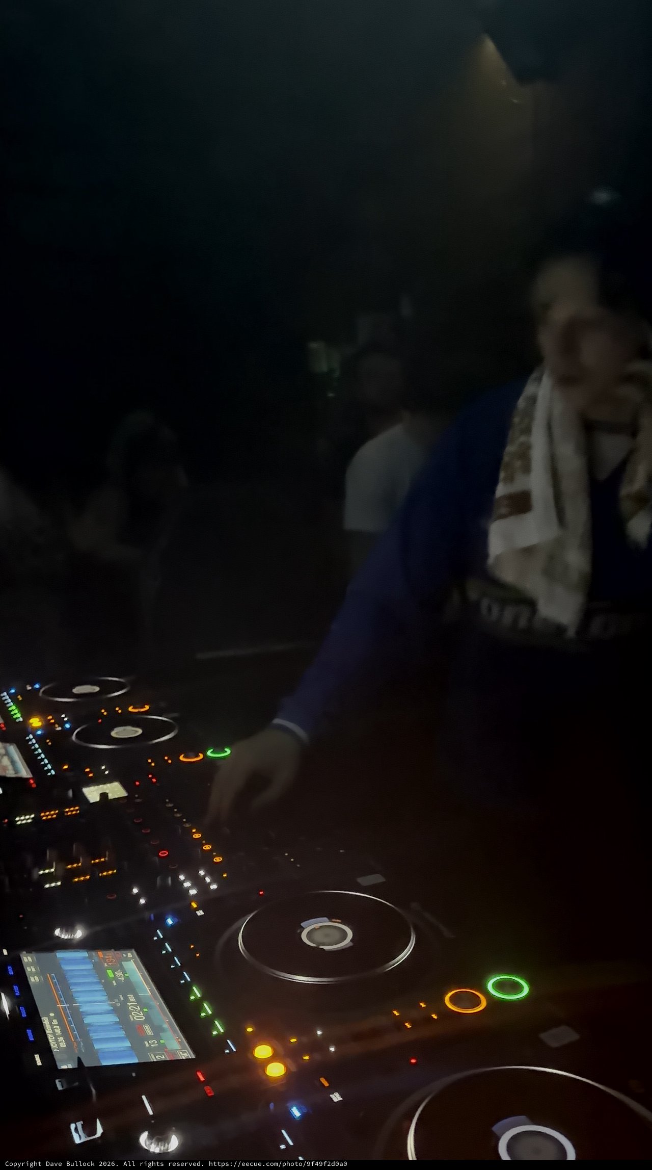 DJ Performance with Pioneer CDJ Controller at Night