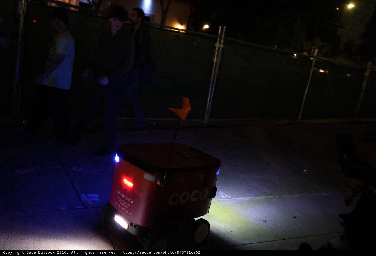Coco Delivery Robot Navigates Sidewalk at Night Festival