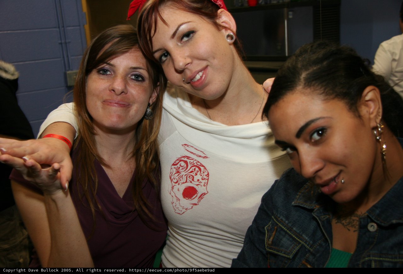 Three Friends Posing Together at a Party