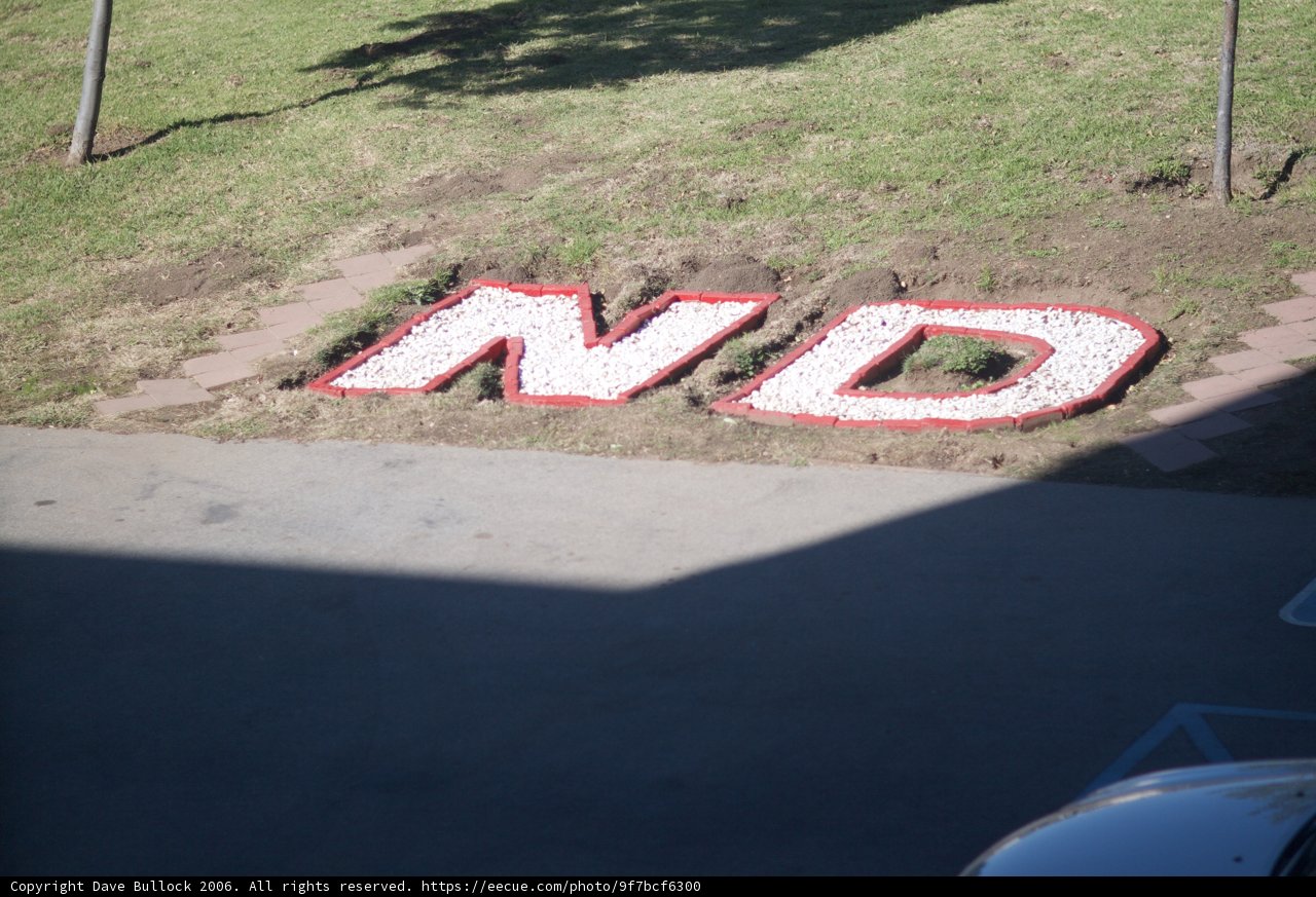 Red and White Sign on Grass Path