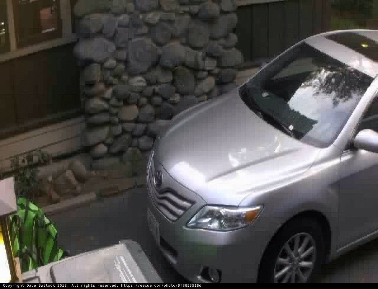 Shimmering Silver Car in Front of a Cozy House