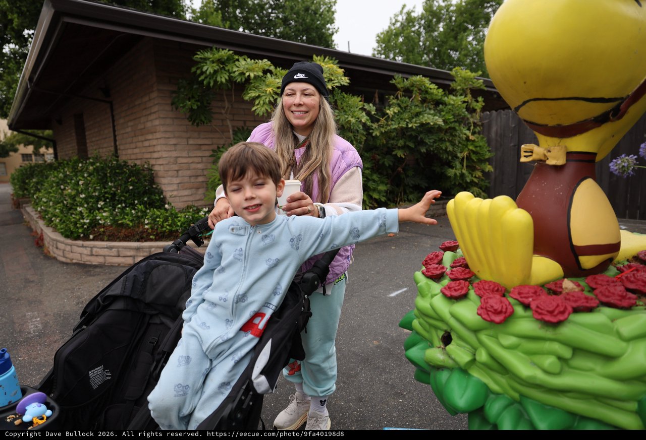 Child Reaches for Woodstock Statue at Balloon Festival