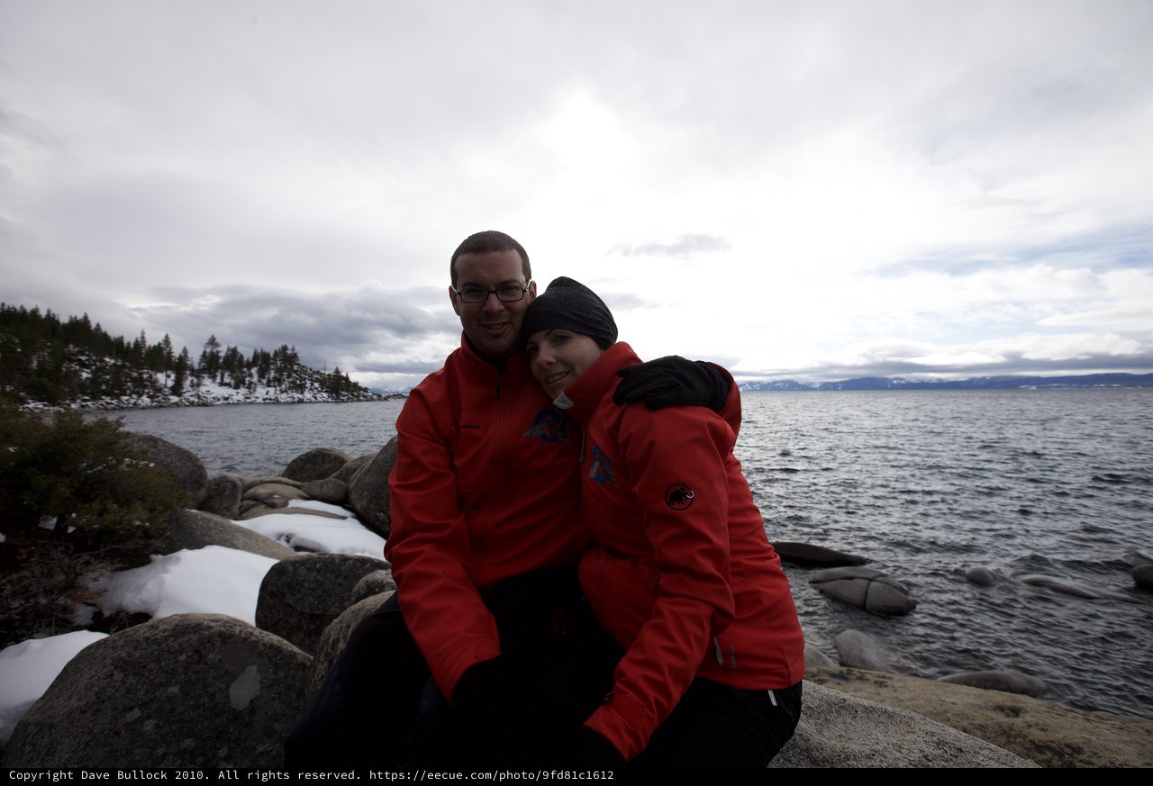 Couple Embracing by Snowy Lake Tahoe Shore
