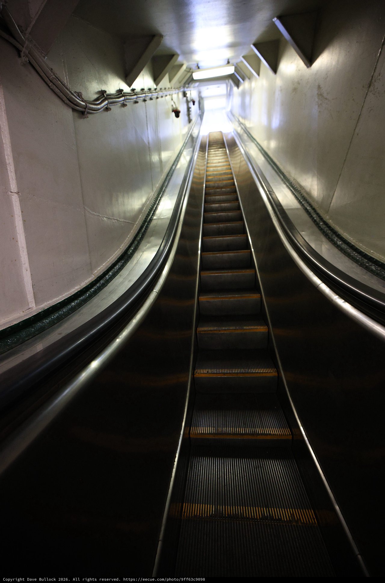 Deep Underground Escalator in Stark Tunnel Corridor