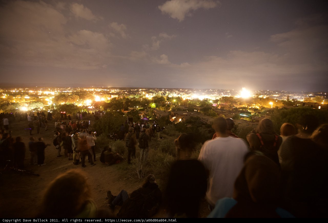 Fireworks Ignite the Night Sky Above a Crowded Plaza