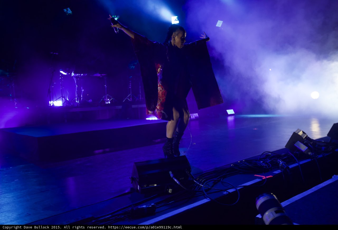 FKA twigs Full Body Wide Arms Spread Wide Silhouette Red Brocade Kimono Black Bodysuit Boots Arm Raised Microphone Moon Band Heavy Haze