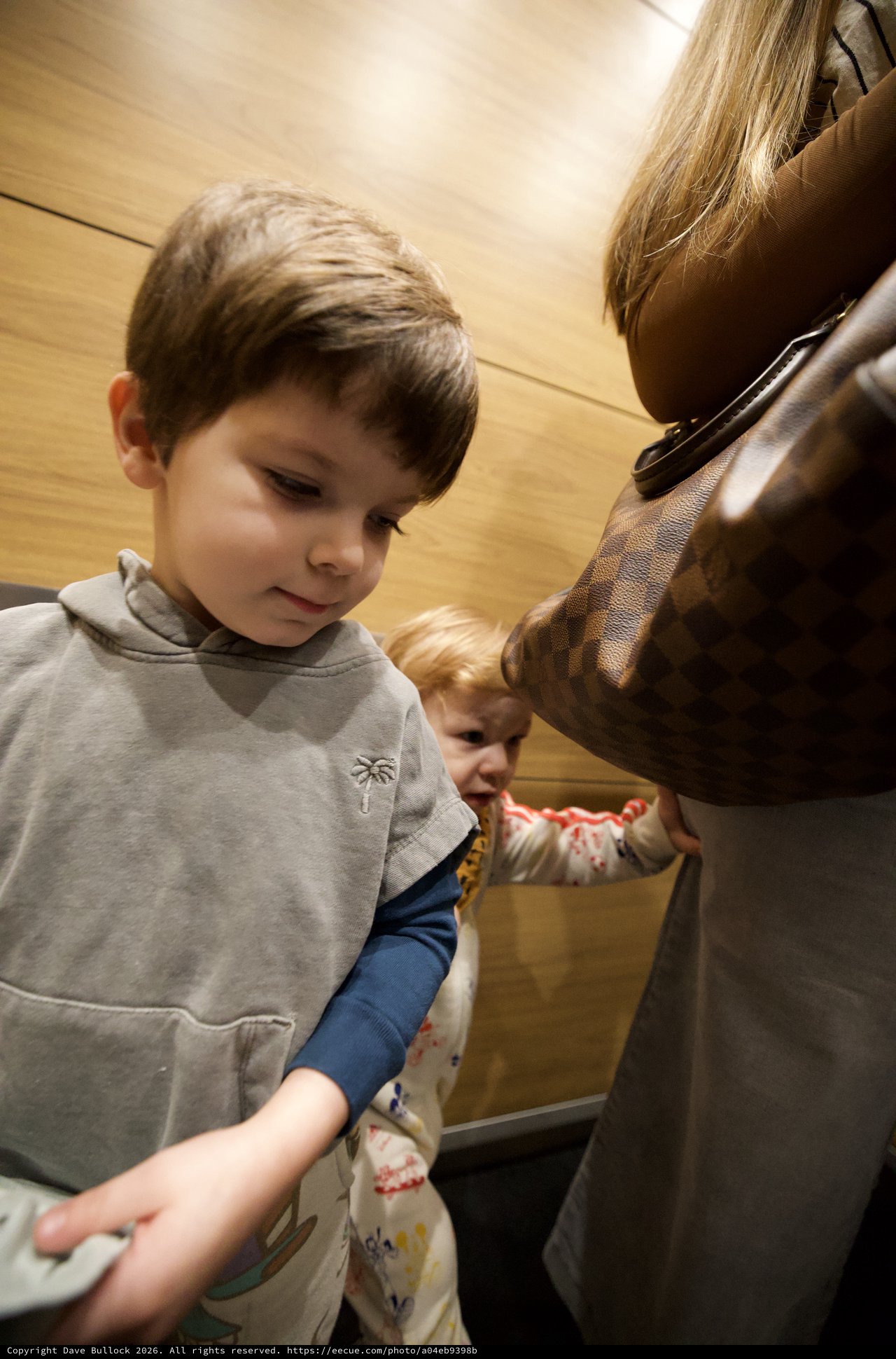 Children Exploring Museum Statue with Parent