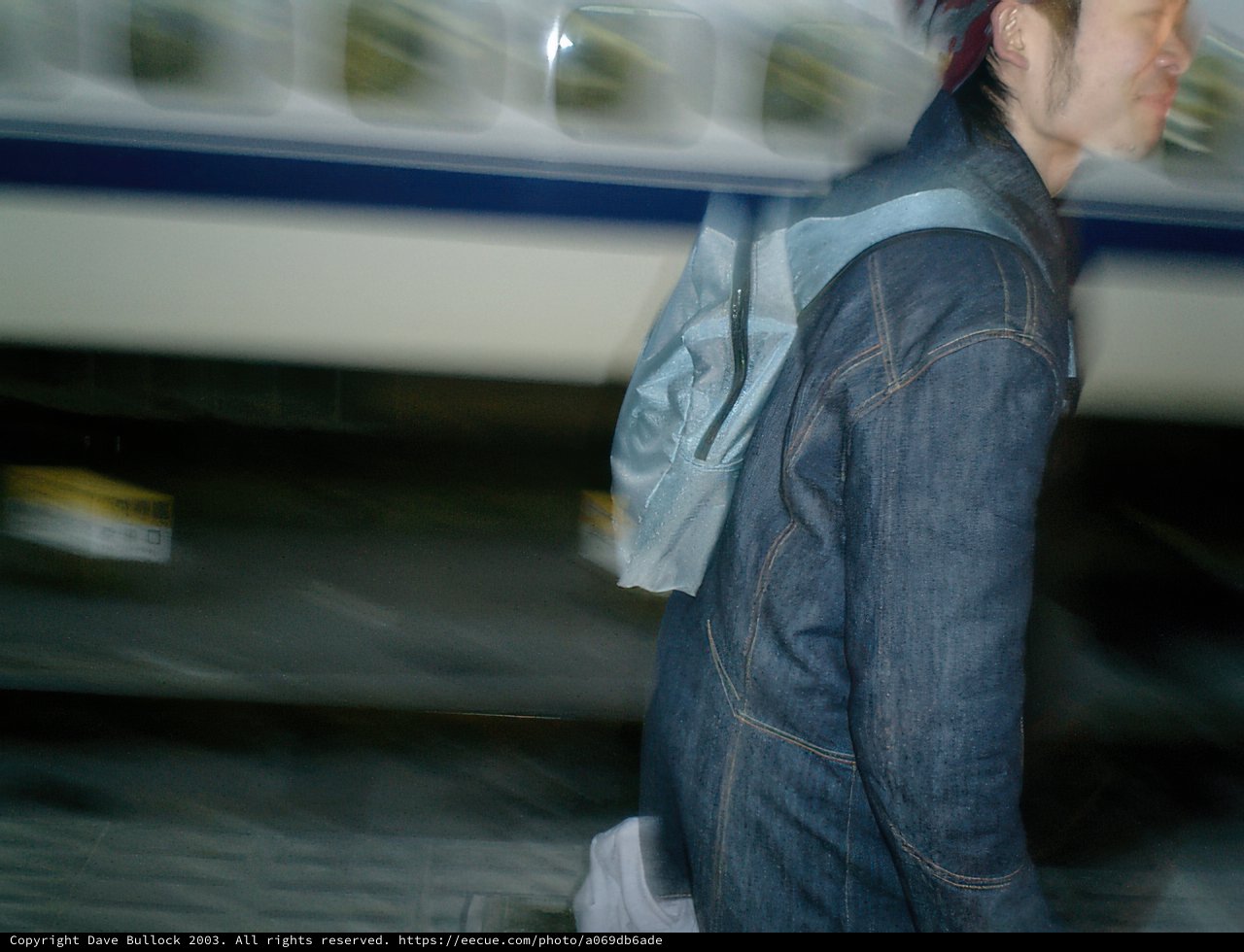 Man Walking in Front of Train at Tokyo Station
