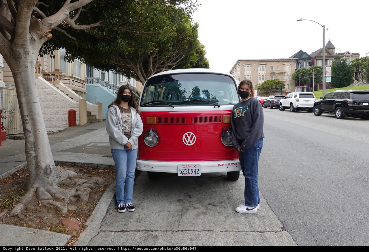 Friends Posing with Classic Red Volkswagen Bus