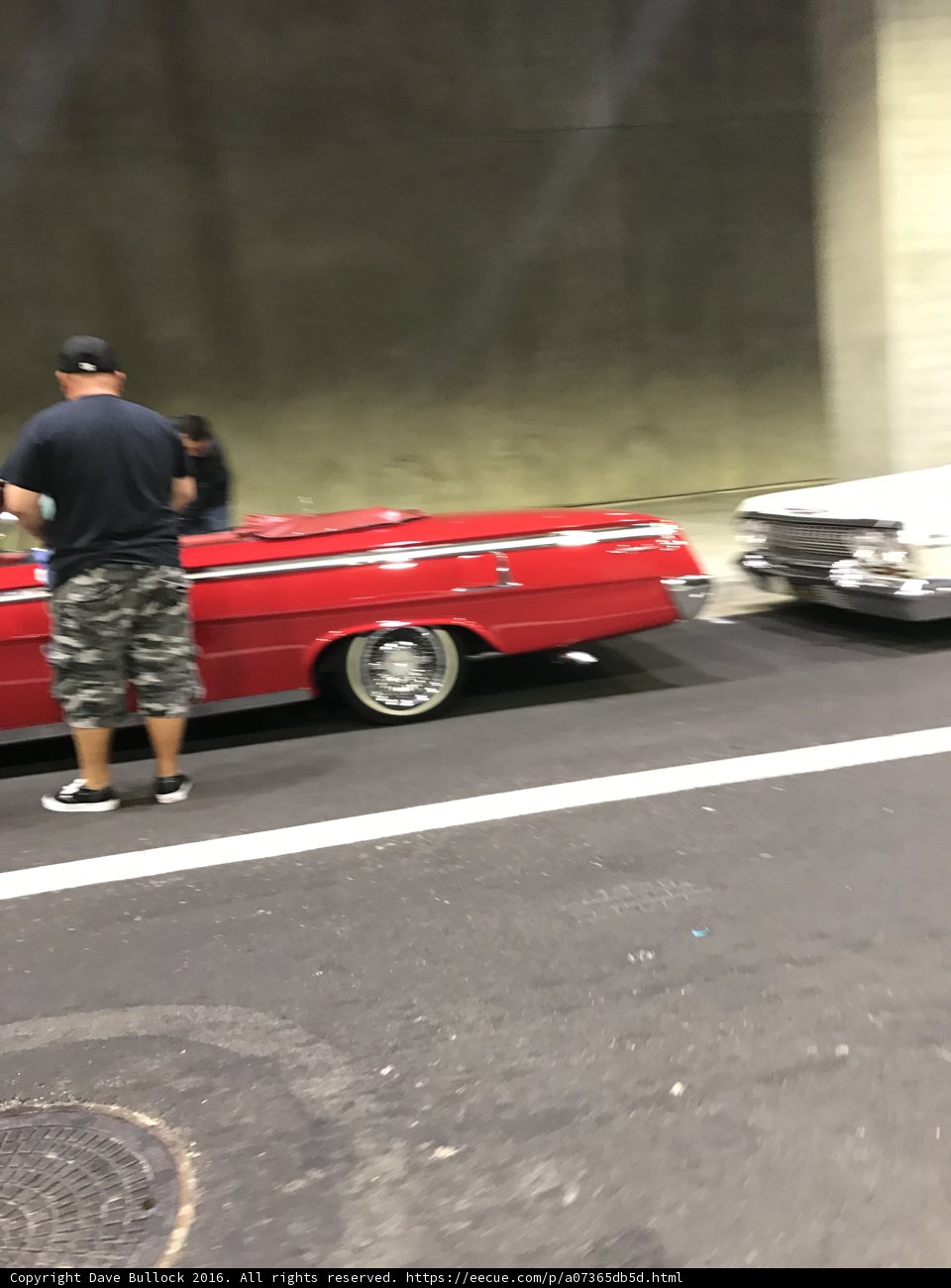 Red Coupe and a Man in Shorts