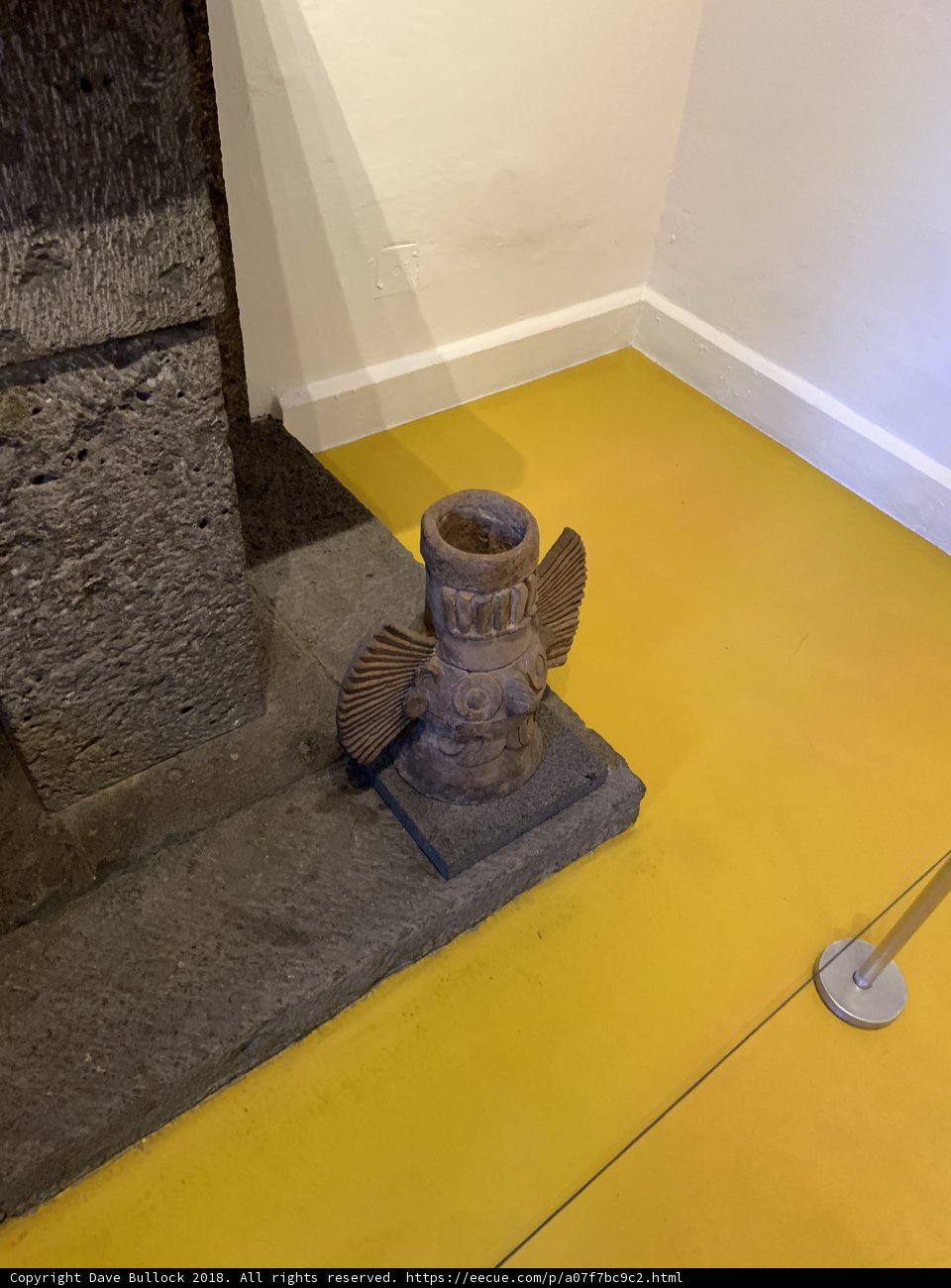 Stone Emblem on Yellow Wood Flooring
