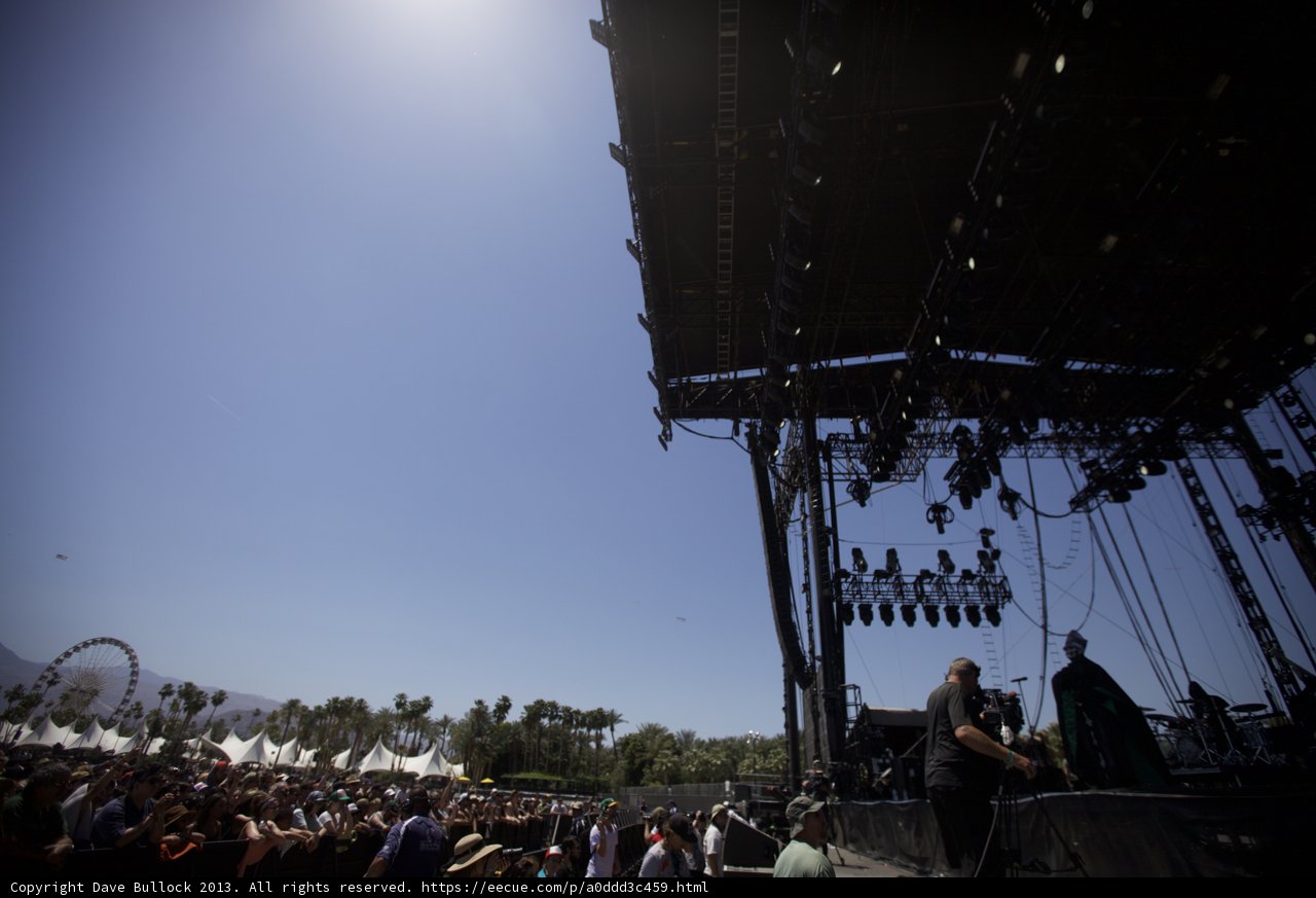 Blue Skies and Electric Vibes Caption: The crowd gathers under a clear sky to dance and sing along to their favorite performers at Coachella Weekend 2, Day 3.