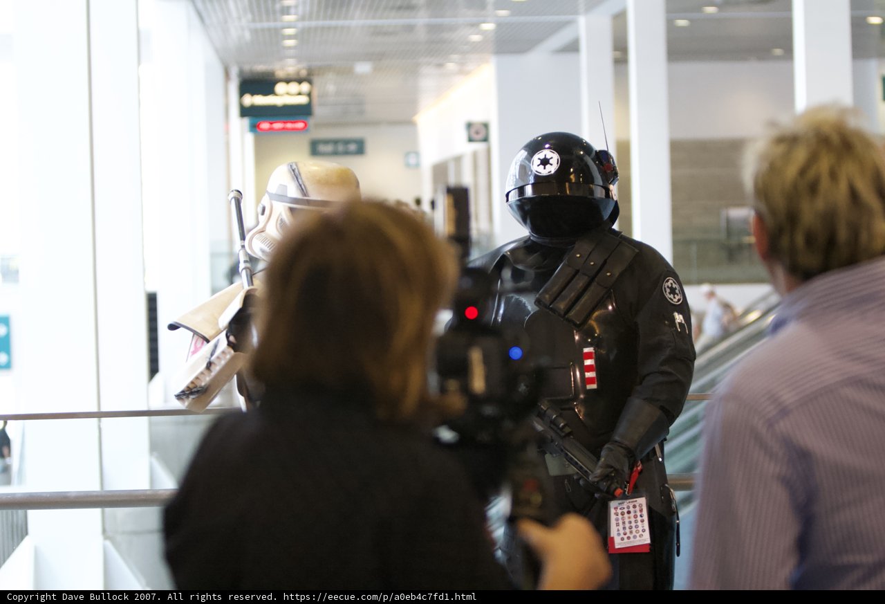 Cosplay Heroes Caption: A man and woman dressed in armored suits and helmets pose for a photo at the Star Wars convention in 2007.