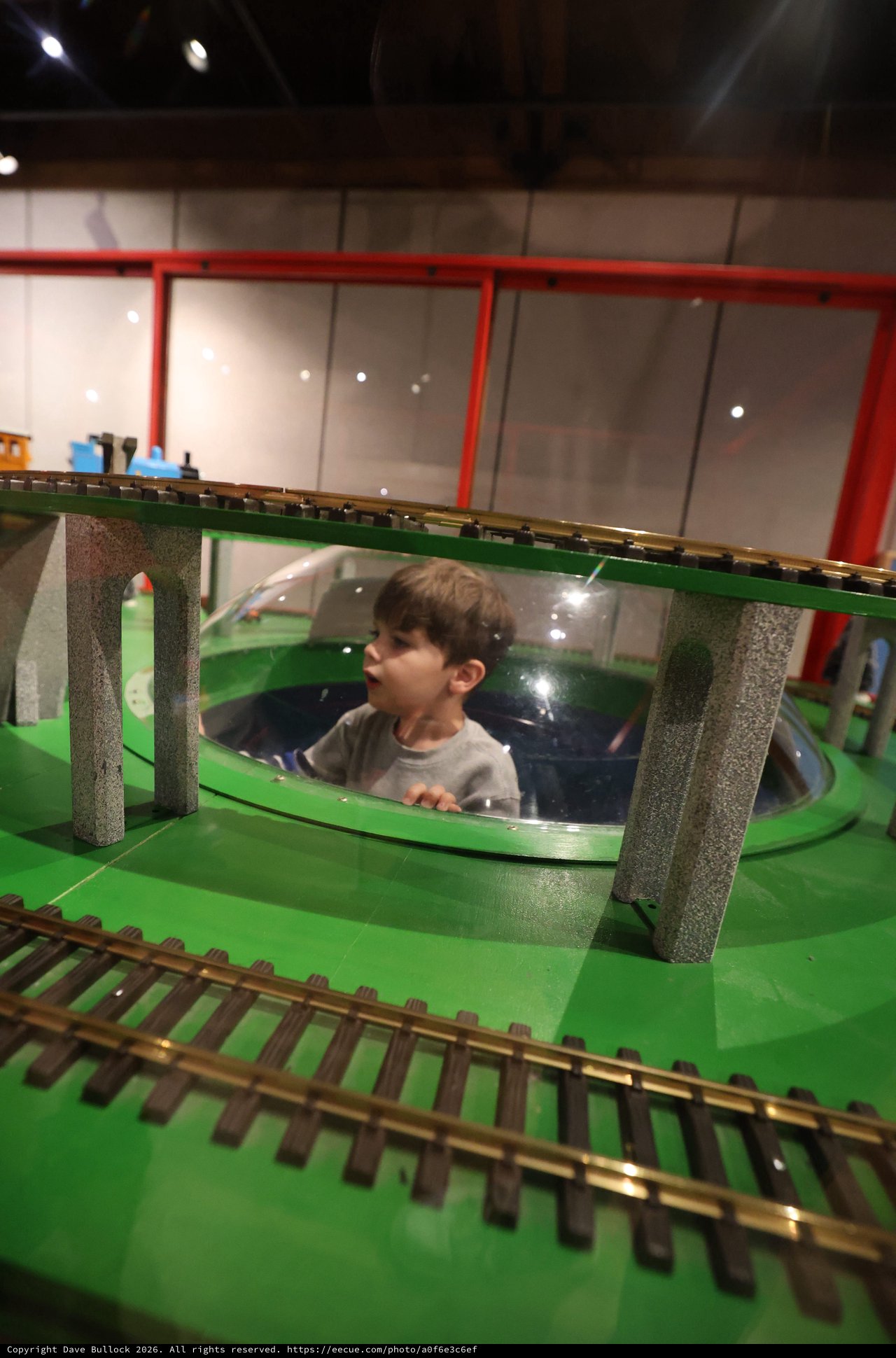 Child Exploring Interactive Train Museum Display