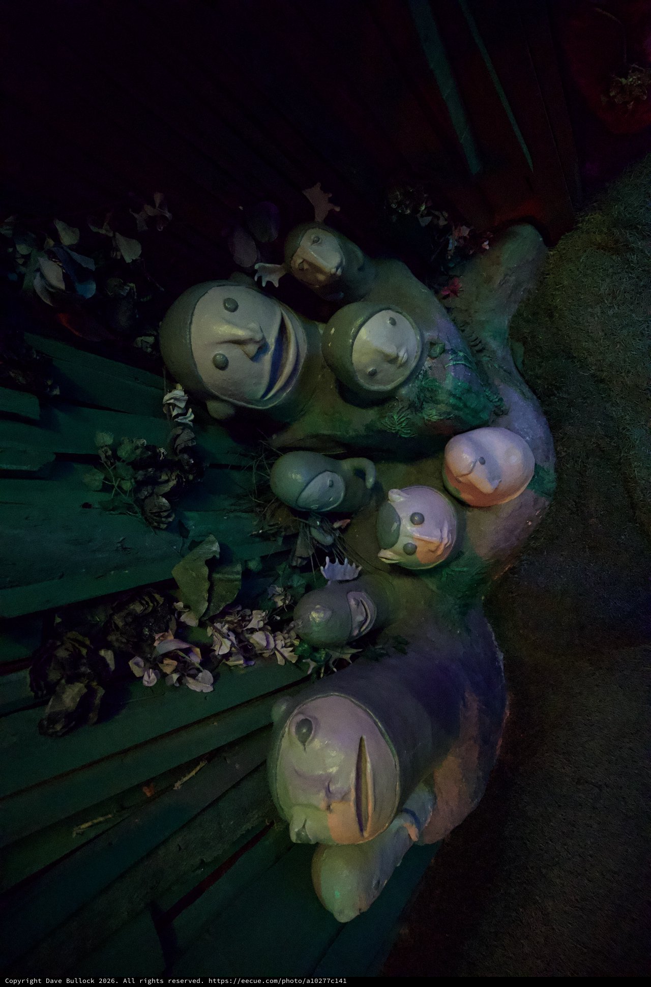 Whimsical Snowman Family Display in Atmospheric Lighting