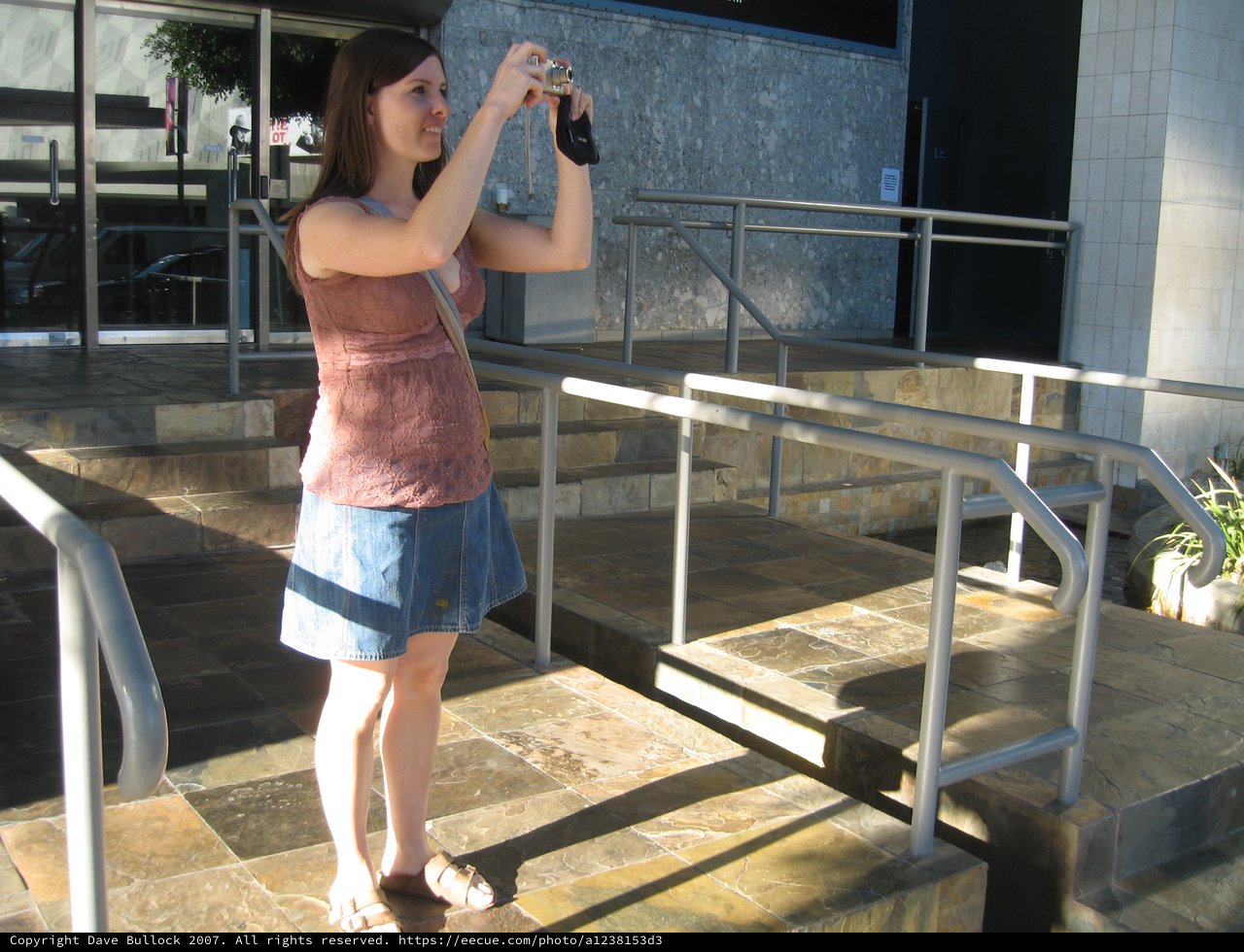 Tourist Photographer Capturing Moments on Museum Steps