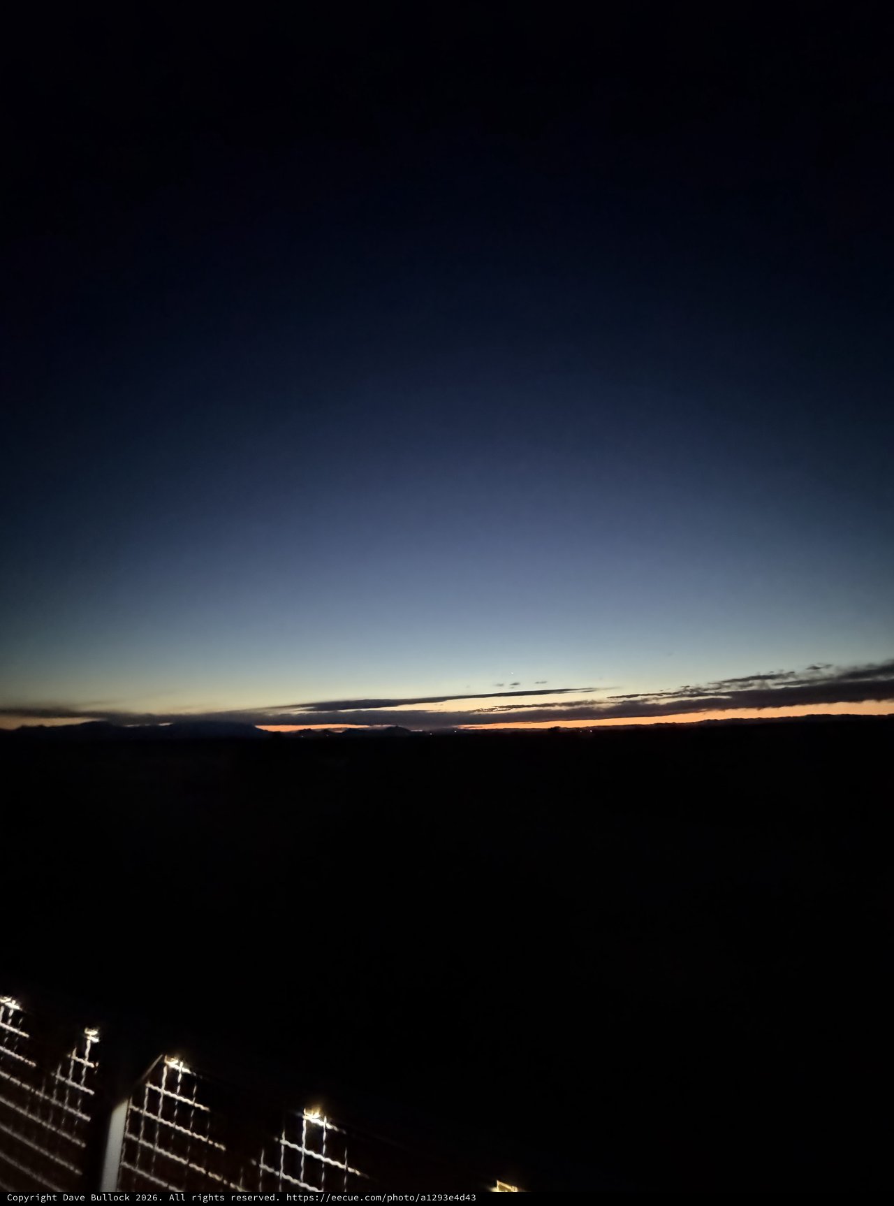 Twilight Glow Over Dark Desert Horizon