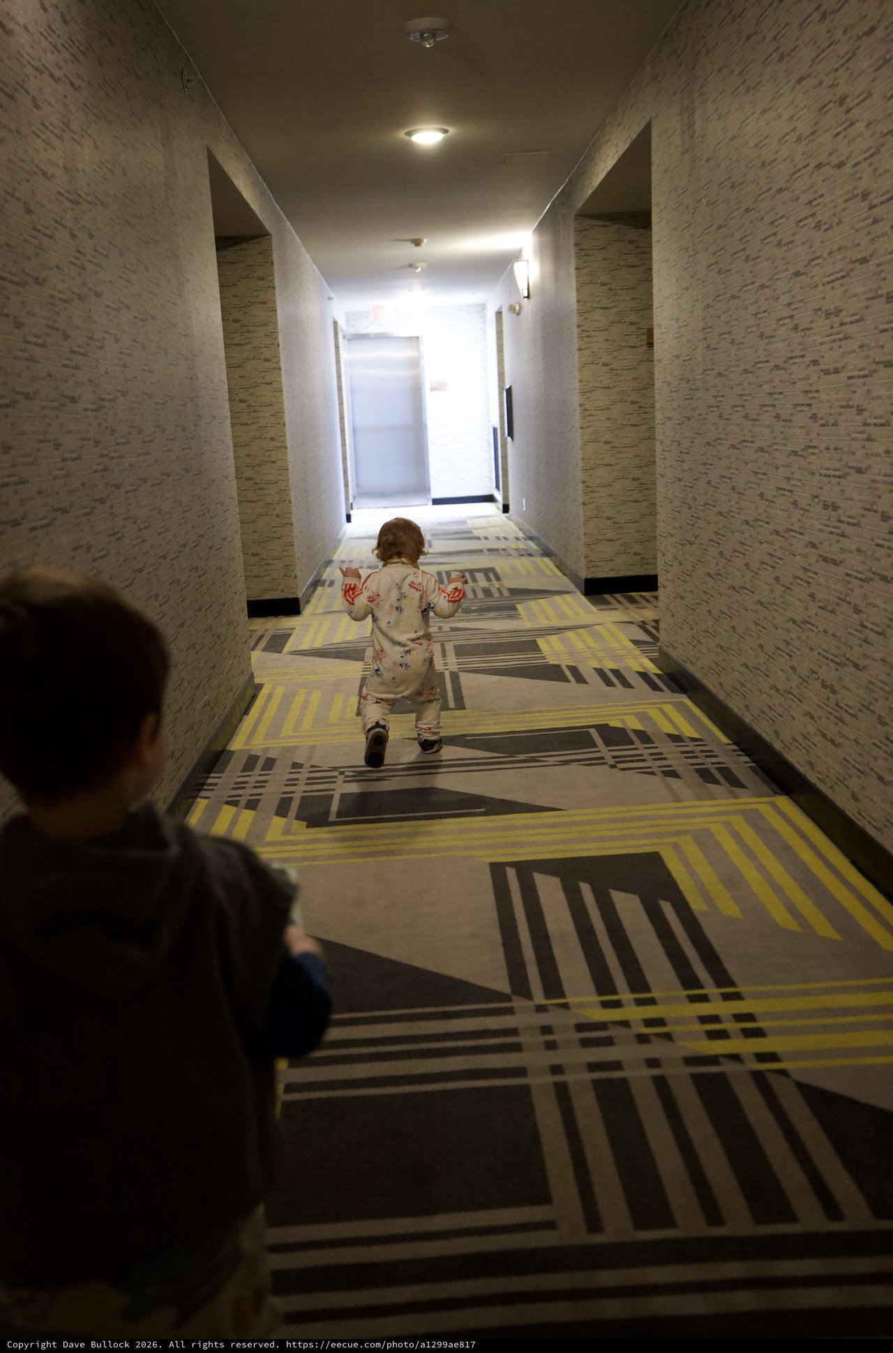 Children Playing in Modern Hotel Corridor at Dusk