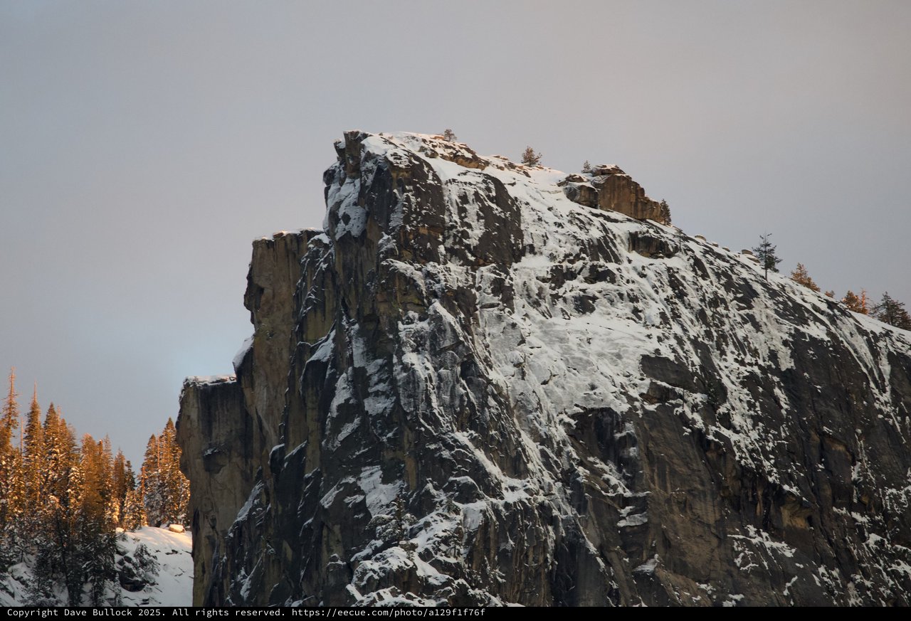 Snow-Covered Rock Pinnacle in Winter Mountain Forest
