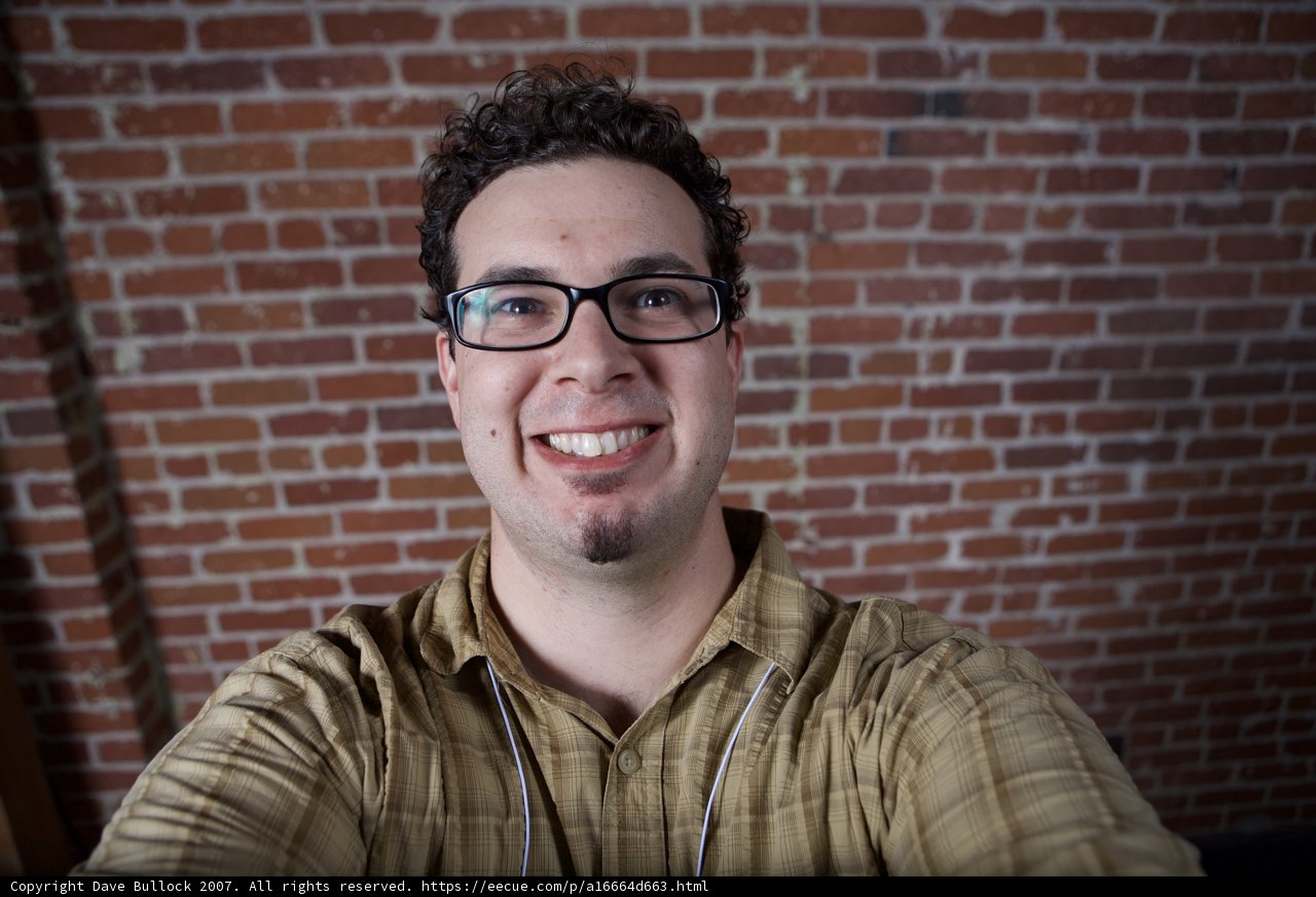 Happy Man in Plaid Shirt and Glasses