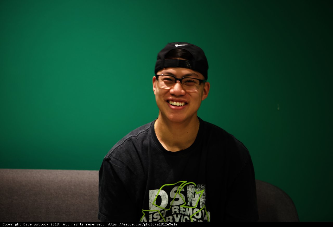 Smiling Man in a Black Hat and Shirt