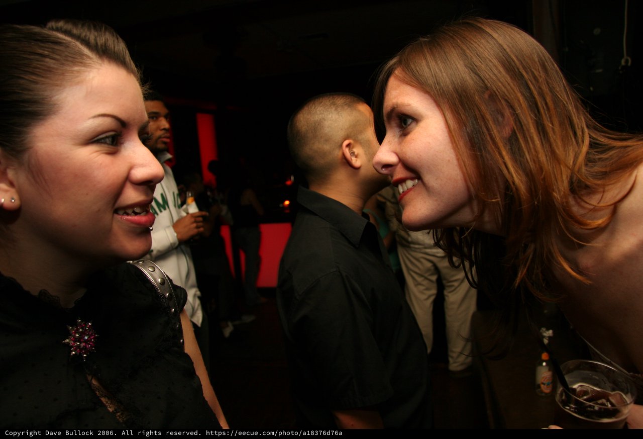 Two Women Share a Moment at a Nightclub