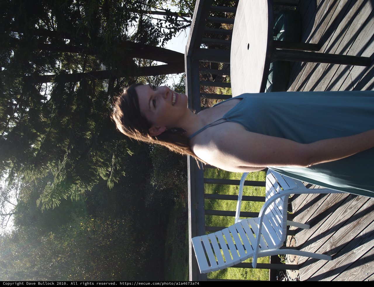 Joyful Woman Relaxing on Sunlit Outdoor Deck
