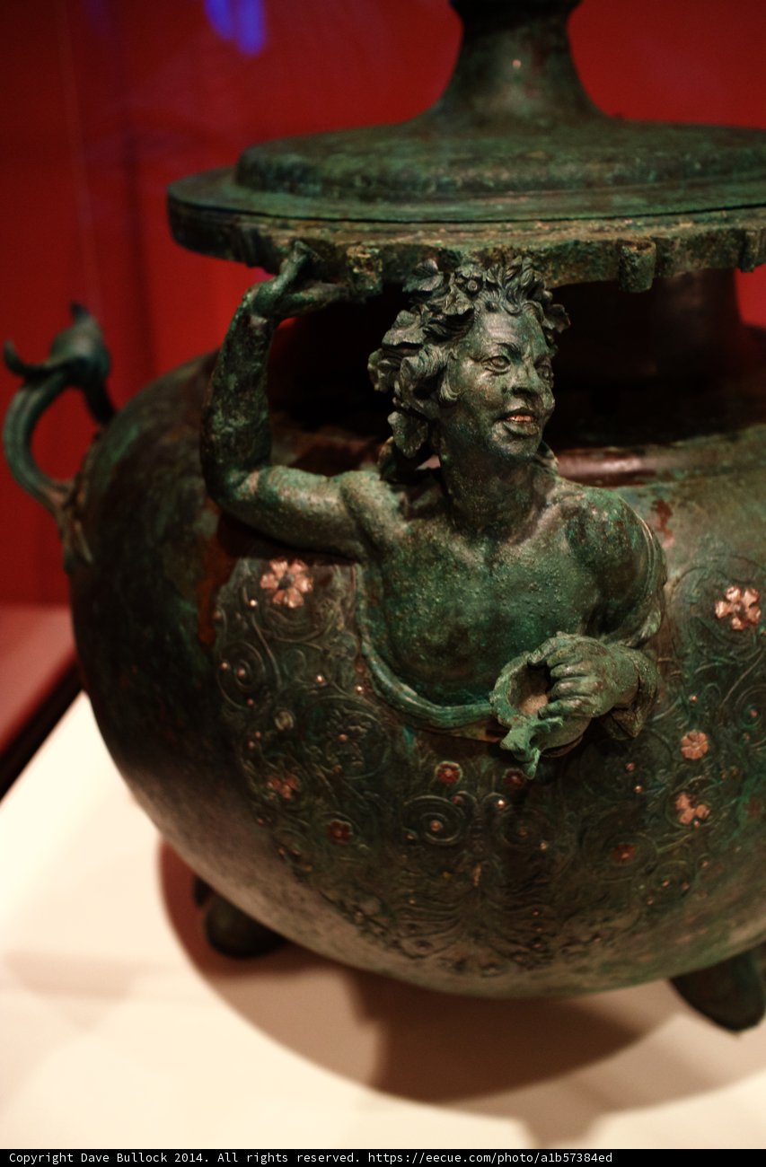 Bronze sculpture of man with bird on head