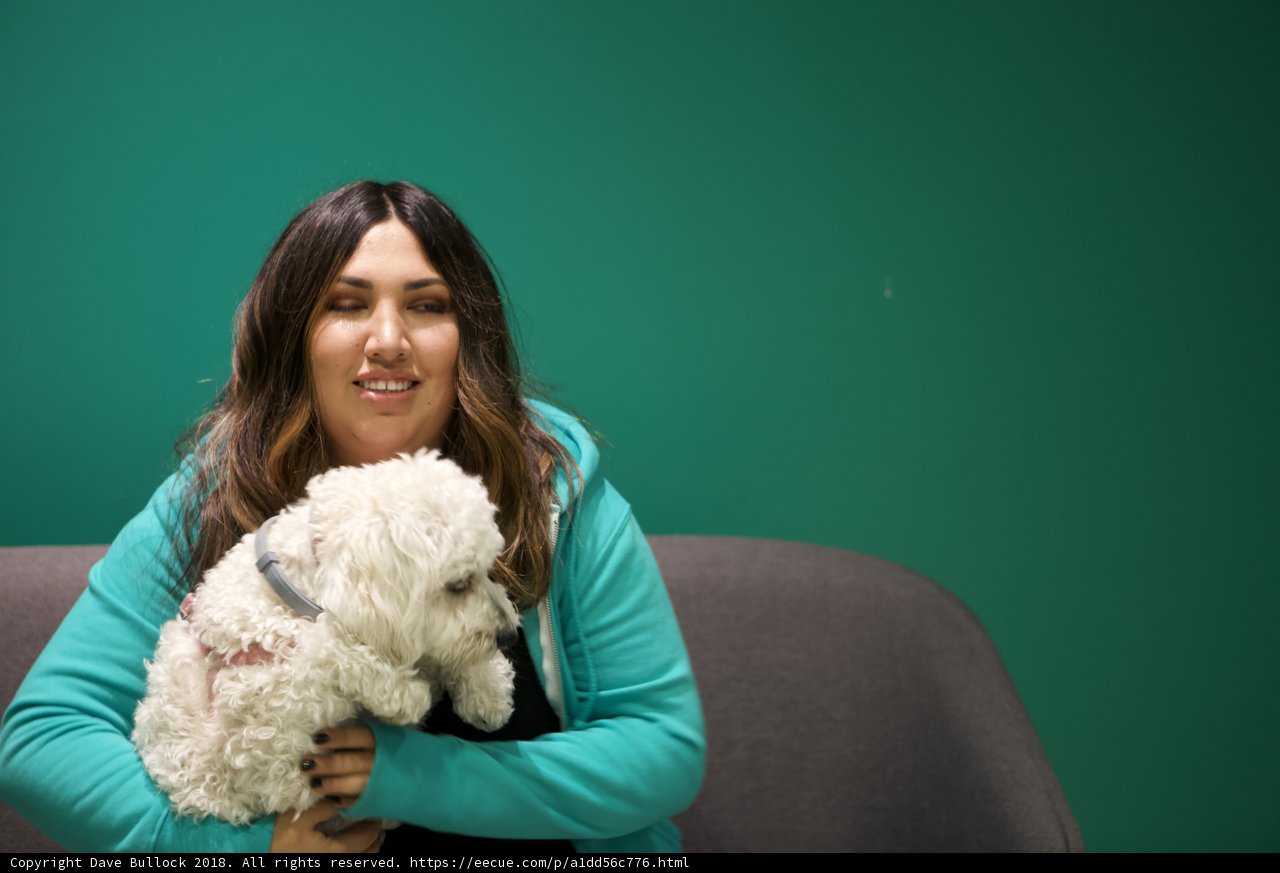 A Happy Woman and Her White Poodle