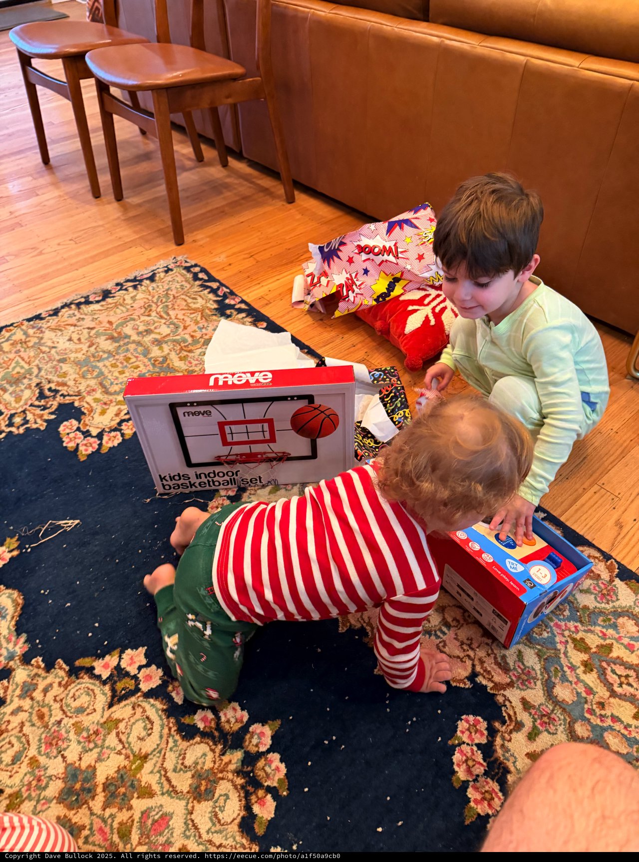 Children Opening Christmas Presents on Living Room Floor