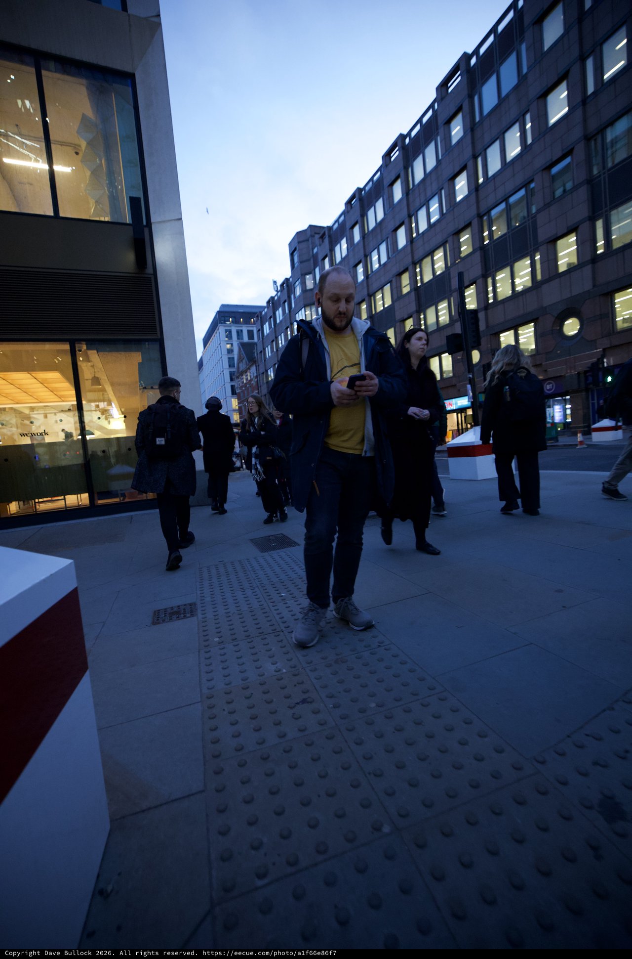 Urban Commuters on Modern London Street at Dusk