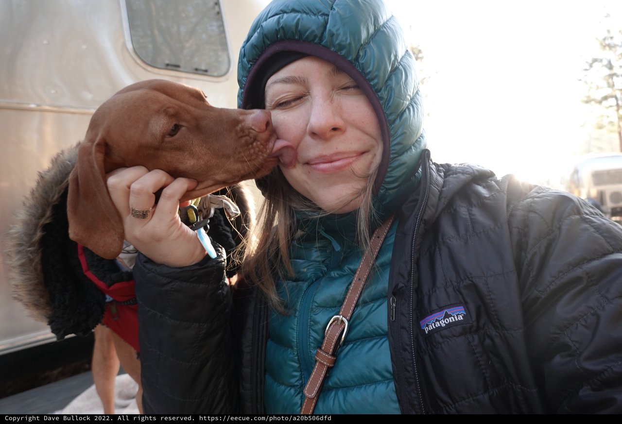 Woman and Dog Share Loving Moment Outside RV