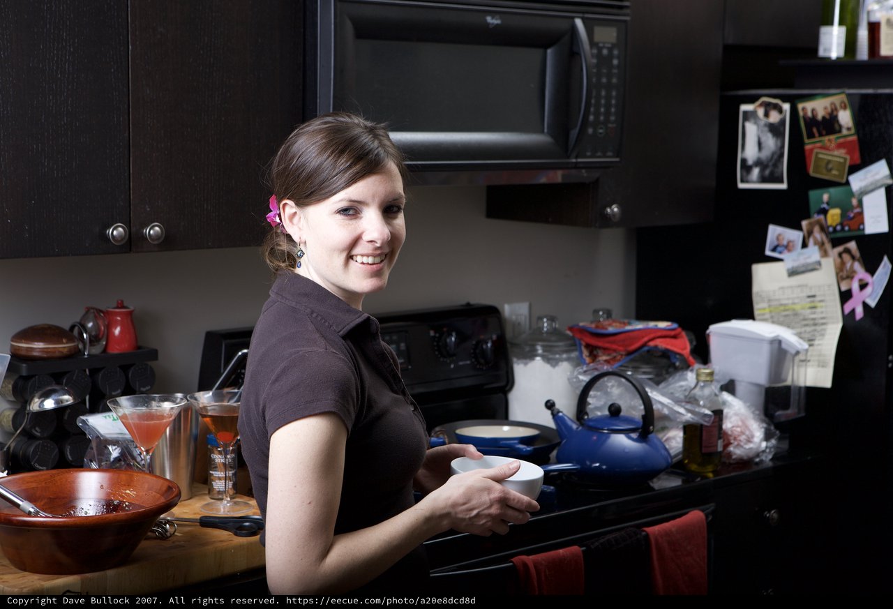 Smiling Woman Cooking in a Cozy Home Kitchen