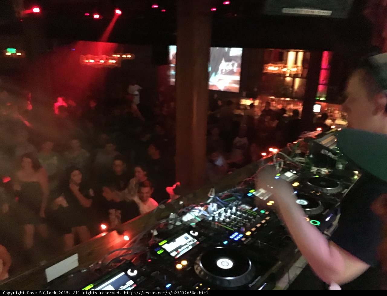 DJ spinning at crowded night club